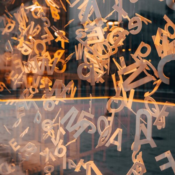 wooden alphabets hanging near glass window